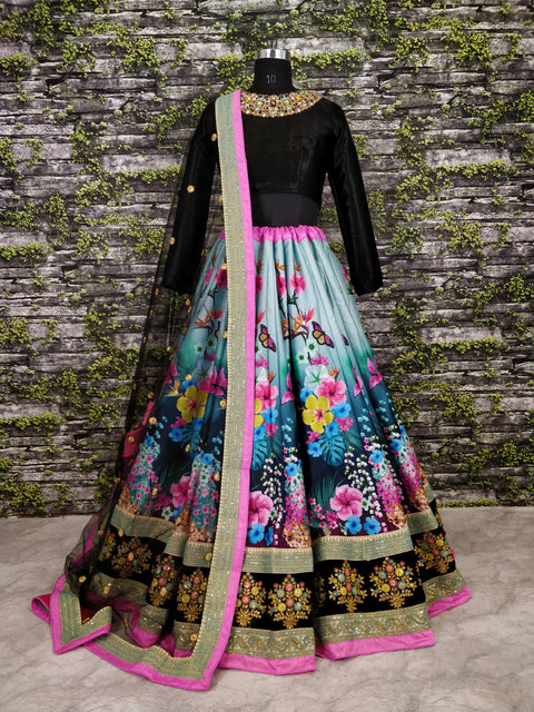 black Gorgeous colourful lehenga featured escapade of florals with Black Silk Valvet choli intricate pastel embellished neckline.