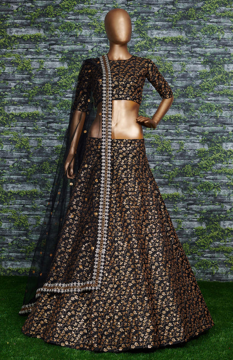 Featuring a black[color] Raw silk lehenga with golden zari embroidered in vine pattern accentuated with golden sequins all over lehenga choli for women