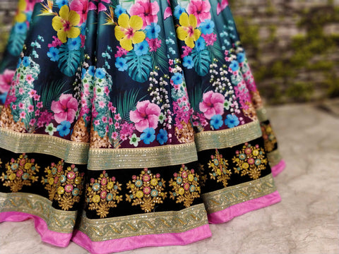 black Gorgeous colourful lehenga featured escapade of florals with Black Silk Valvet choli intricate pastel embellished neckline.