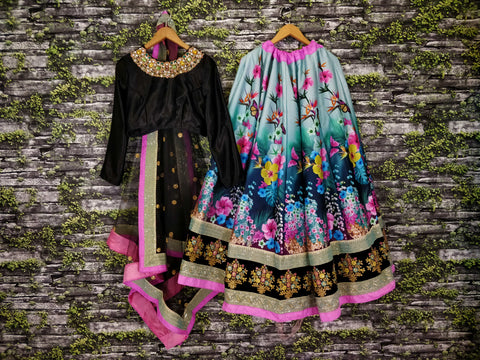 black Gorgeous colourful lehenga featured escapade of florals with Black Silk Valvet choli intricate pastel embellished neckline.