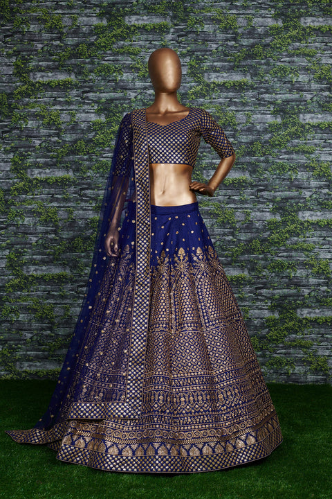 Featuring an Navy Blue raw silk blouse adorned with gold sequin embroidery lehenga choli for women