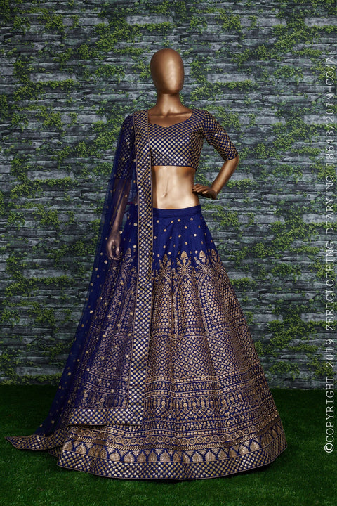 Featuring an Navy Blue raw silk blouse adorned with gold sequin embroidery lehenga choli for women