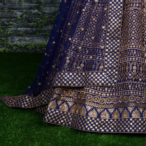 Featuring an Navy Blue raw silk blouse adorned with gold sequin embroidery lehenga choli for women