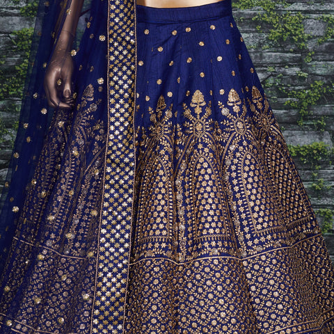 Featuring an Navy Blue raw silk blouse adorned with gold sequin embroidery lehenga choli for women