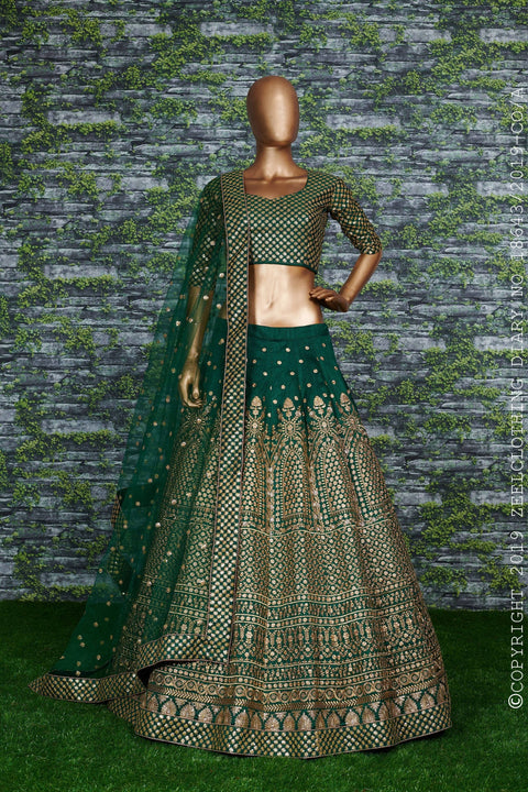 Green raw silk blouse adorned with gold sequin embroidery lehenga choli for women